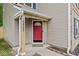Close-up of the red front door with house number, covered porch, and neatly landscaped entrance at 3803 Churchman Woods Blvd, Indianapolis, IN 46203