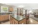 Spacious kitchen with island, seamlessly flowing into the dining area and cozy living room at 3803 Churchman Woods Blvd, Indianapolis, IN 46203