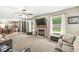 A cozy living room featuring a fireplace, large windows, and access to the kitchen at 3803 Churchman Woods Blvd, Indianapolis, IN 46203