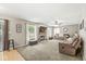 Comfortable living room with a fireplace, plush seating, and large windows for natural light at 3803 Churchman Woods Blvd, Indianapolis, IN 46203