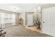 Open-concept living room featuring a large window, neutral tones, and welcoming entrance at 3803 Churchman Woods Blvd, Indianapolis, IN 46203