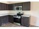 Well-equipped kitchen featuring dark cabinetry, stainless steel appliances, and new countertops for a modern look at 3805 Windstar Way, Columbus, IN 47203