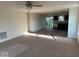 Bright living room featuring carpet, neutral walls, and ample sunlight, creating a warm and inviting space at 3805 Windstar Way, Columbus, IN 47203