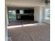 Spacious living room with carpet, open layout and natural light filtering through the windows and sliding glass door at 3805 Windstar Way, Columbus, IN 47203