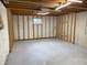 Unfinished basement with concrete floor, stud walls, and a small window offers potential for customization at 3916 Jekyll Ct, Indianapolis, IN 46237