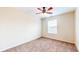A cozy carpeted bedroom with a window and ceiling fan offers a comfortable and serene retreat at 3916 Jekyll Ct, Indianapolis, IN 46237