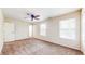 Spacious carpeted bedroom with ceiling fan, natural light, and closet maximizes comfort and functionality at 3916 Jekyll Ct, Indianapolis, IN 46237
