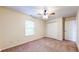Carpeted bedroom featuring neutral walls, a window, ceiling fan, and closet offers a relaxing and bright atmosphere at 3916 Jekyll Ct, Indianapolis, IN 46237