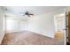 This carpeted bedroom has neutral walls, a ceiling fan, a closet with doors, and a door to another room at 3916 Jekyll Ct, Indianapolis, IN 46237