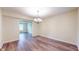 Dining room with wood flooring and an elegant chandelier at 3916 Jekyll Ct, Indianapolis, IN 46237