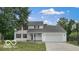 Charming two-story home with red shutters, a well-manicured lawn, and an attached two-car garage at 3916 Jekyll Ct, Indianapolis, IN 46237