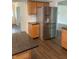 Stainless steel refrigerator in an open kitchen with wooden cabinets at 3916 Jekyll Ct, Indianapolis, IN 46237