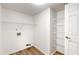 Bright laundry room with vinyl flooring, shelving, and washer/dryer hookups at 3916 Jekyll Ct, Indianapolis, IN 46237