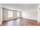Open living area featuring wood flooring and natural light from two large windows at 3916 Jekyll Ct, Indianapolis, IN 46237