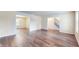 Spacious living room featuring wood flooring and ample natural light from large windows at 3916 Jekyll Ct, Indianapolis, IN 46237