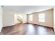 Bright living room with wood floors, neutral walls, and staircase access at 3916 Jekyll Ct, Indianapolis, IN 46237