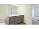 Bathroom featuring a large mirror, gray vanity, and view to the next room at 3927 Wren Dr, Brownsburg, IN 46112