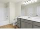 Well-lit bathroom with a shower-tub combo and vanity with gray cabinets and a large mirror at 3927 Wren Dr, Brownsburg, IN 46112