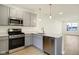 Updated kitchen with stainless steel appliances, a dishwasher and gray cabinets at 3927 Wren Dr, Brownsburg, IN 46112