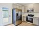 Updated kitchen with stainless steel refrigerator and gas range plus modern, light-colored cabinets at 3927 Wren Dr, Brownsburg, IN 46112