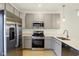 This kitchen features stainless steel appliances, light gray cabinetry, and quartz countertops at 3927 Wren Dr, Brownsburg, IN 46112