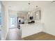 Bright kitchen with stainless steel appliances, light gray cabinetry, and hardwood floors at 3927 Wren Dr, Brownsburg, IN 46112