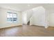 A bright open-concept living area with large windows and wood-look flooring at 3927 Wren Dr, Brownsburg, IN 46112