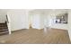 Open-concept living room featuring hardwood floors, a modern kitchen, and stairway access at 3927 Wren Dr, Brownsburg, IN 46112