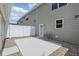 Backyard with concrete patio, white fence, rock ground cover, and neutral colored siding at 3947 Wren Dr, Brownsburg, IN 46112