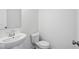 A well-lit bathroom with a toilet, sink, and white walls at 3947 Wren Dr, Brownsburg, IN 46112