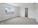 Bright bedroom with large window, neutral carpet, and a walk-in closet for ample storage at 3947 Wren Dr, Brownsburg, IN 46112