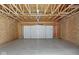Spacious garage with exposed ceiling and concrete floor, providing ample parking and storage at 3947 Wren Dr, Brownsburg, IN 46112