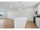 Open kitchen design with center island, hardwood flooring, and modern appliances at 3947 Wren Dr, Brownsburg, IN 46112
