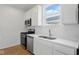 Modern kitchen features stainless steel appliances, white cabinetry, and solid surface countertops at 3947 Wren Dr, Brownsburg, IN 46112