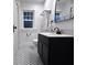 Elegant bathroom featuring a dark vanity, classic fixtures, and tiled flooring at 4040 Carrollton Ave, Indianapolis, IN 46205