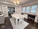 Bright dining room with large windows, stylish furnishings, and hardwood floors at 4040 Carrollton Ave, Indianapolis, IN 46205