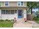 Close up front of a inviting home with a charming blue front door at 4040 Carrollton Ave, Indianapolis, IN 46205