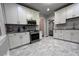 Well-lit kitchen featuring white cabinets, modern appliances, and stylish backsplash at 4040 Carrollton Ave, Indianapolis, IN 46205