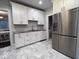 Modern kitchen featuring stainless steel appliances, granite countertops, and white cabinets at 4040 Carrollton Ave, Indianapolis, IN 46205