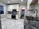 Modern kitchen featuring stainless steel appliances, granite countertops, and white cabinets at 4040 Carrollton Ave, Indianapolis, IN 46205