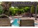 Backyard featuring an in-ground pool, pergola, hot tub, and mature trees at 4420 Hickory Ridge Blvd, Greenwood, IN 46143