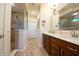 This bathroom features double sinks, a large mirror, decorative tile work, and a step-in shower at 4420 Hickory Ridge Blvd, Greenwood, IN 46143