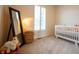 This Bedroom features natural light, a full-length mirror, and a crib at 4420 Hickory Ridge Blvd, Greenwood, IN 46143