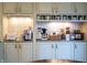 Dedicated coffee bar area includes custom cabinetry, granite countertops, and beverage appliances at 4420 Hickory Ridge Blvd, Greenwood, IN 46143