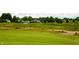 Scenic golf course showcasing rolling greens, surrounding buildings, and natural beauty at 4420 Hickory Ridge Blvd, Greenwood, IN 46143