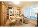 This home office features plantation shutters, built-in cabinets, a desk, and a massage chair at 4420 Hickory Ridge Blvd, Greenwood, IN 46143