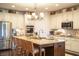 Bright kitchen features a granite island with seating, modern stainless appliances, and decorative shelving at 4420 Hickory Ridge Blvd, Greenwood, IN 46143