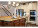 Kitchen island featuring bar stool seating, granite counters, and a stainless steel dishwasher at 4420 Hickory Ridge Blvd, Greenwood, IN 46143