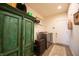 Well-equipped laundry area with a green cabinet for storage and modern washer and dryer units at 4420 Hickory Ridge Blvd, Greenwood, IN 46143