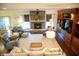 Spacious living room featuring a stone fireplace, a custom entertainment center, and ample seating at 4420 Hickory Ridge Blvd, Greenwood, IN 46143
